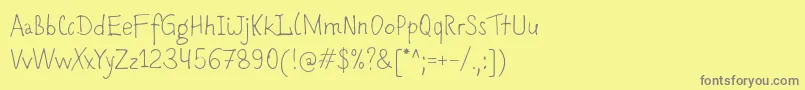 フォントRomochka – 黄色の背景に灰色の文字