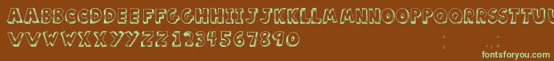フォントScoolarTfb – 緑色の文字が茶色の背景にあります。
