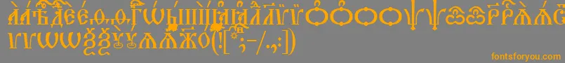 フォントTriodionCapsUcs – オレンジの文字は灰色の背景にあります。