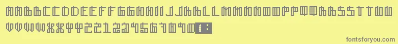 Lain-fontti – harmaat kirjasimet keltaisella taustalla