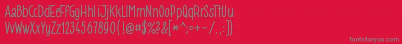 Gomezb009-fontti – harmaat kirjasimet punaisella taustalla