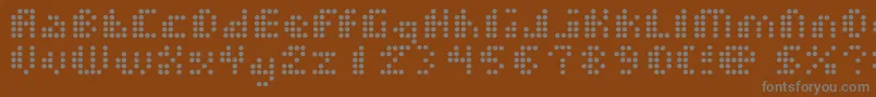 DotShortOfAMatrix-fontti – harmaat kirjasimet ruskealla taustalla