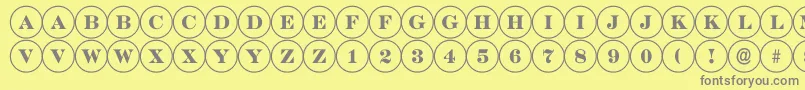 DiscoserifRegular-fontti – harmaat kirjasimet keltaisella taustalla