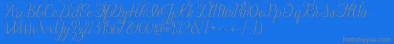 フォントJandacelebrationscript – 青い背景に灰色の文字