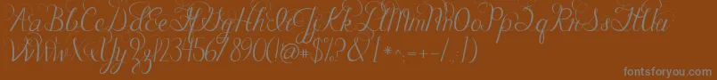 Jandacelebrationscript-Schriftart – Graue Schriften auf braunem Hintergrund