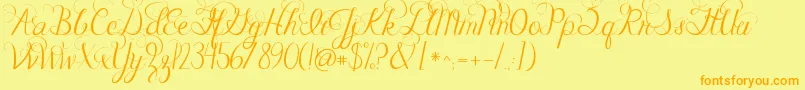 フォントJandacelebrationscript – オレンジの文字が黄色の背景にあります。