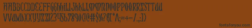 フォントXiphosCondensed – 黒い文字が茶色の背景にあります