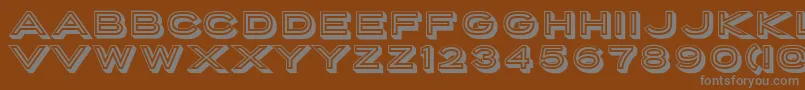 PorterSansInlineBlock-fontti – harmaat kirjasimet ruskealla taustalla
