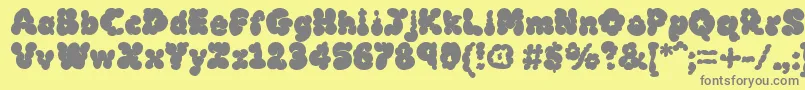 MckloudBlack-fontti – harmaat kirjasimet keltaisella taustalla