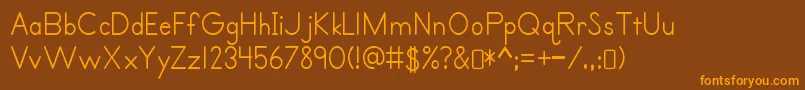 フォントPrimerprint Regular – オレンジ色の文字が茶色の背景にあります。
