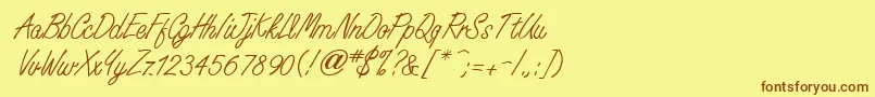 フォントWhisperwriteMedium – 茶色の文字が黄色の背景にあります。