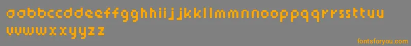 フォントStickyBits – オレンジの文字は灰色の背景にあります。