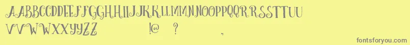 CurelyFreeTypeface-Schriftart – Graue Schriften auf gelbem Hintergrund
