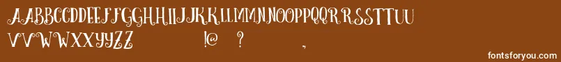 フォントCurelyFreeTypeface – 茶色の背景に白い文字