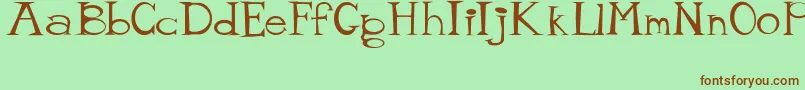 MisterTate Font – Brown Fonts on Green Background