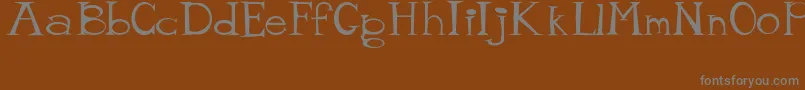 フォントMisterTate – 茶色の背景に灰色の文字