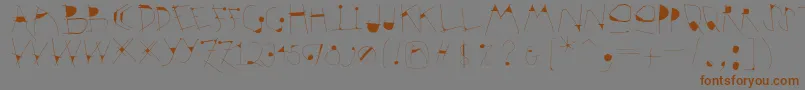 Krakelfabet-Schriftart – Braune Schriften auf grauem Hintergrund