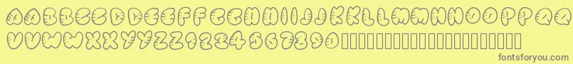 Strippedrounded-fontti – harmaat kirjasimet keltaisella taustalla