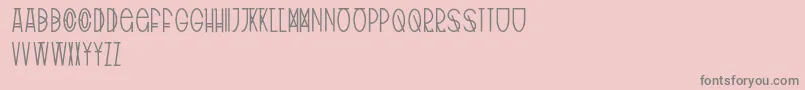 TribalType-fontti – harmaat kirjasimet vaaleanpunaisella taustalla