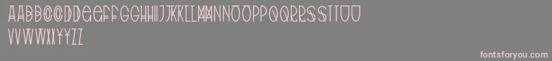 フォントTribalType – 灰色の背景にピンクのフォント