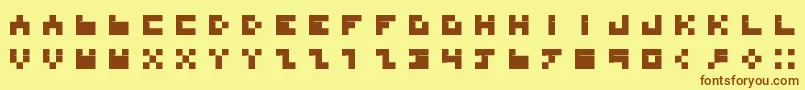 フォントBdTinyfont – 茶色の文字が黄色の背景にあります。