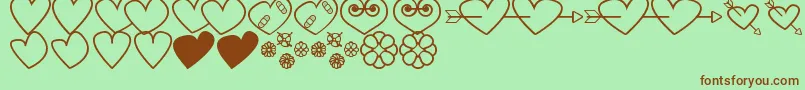 HeartsAndFlowersForValentines-Schriftart – Braune Schriften auf grünem Hintergrund