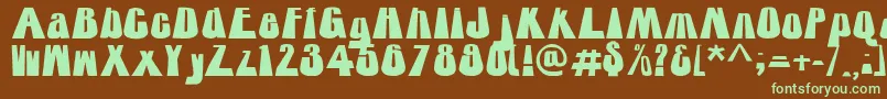 フォントTowering – 緑色の文字が茶色の背景にあります。