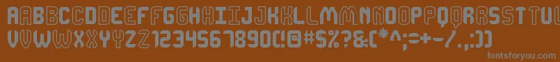 DhonjakoSt Font – Gray Fonts on Brown Background