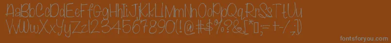 Lawnmowers-fontti – harmaat kirjasimet ruskealla taustalla
