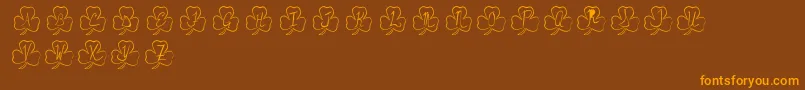 PotOfGold-Schriftart – Orangefarbene Schriften auf braunem Hintergrund