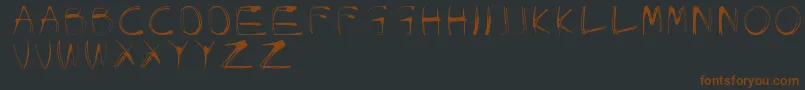 Шрифт GlowCarroDanishSpiik – коричневые шрифты на чёрном фоне
