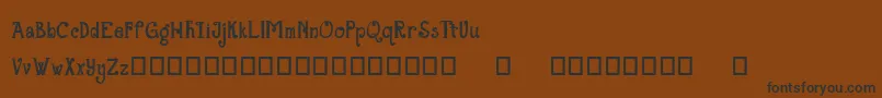 フォントTheGrandStaircase – 黒い文字が茶色の背景にあります