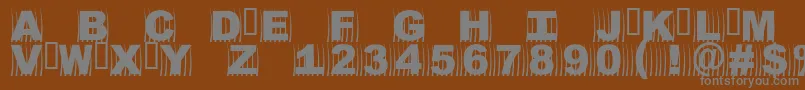 Oszics-fontti – harmaat kirjasimet ruskealla taustalla