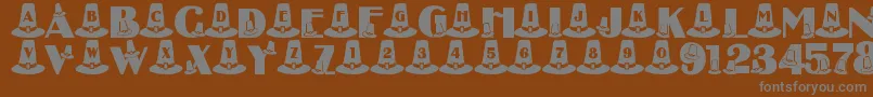 LmsPuritanPartyHats-fontti – harmaat kirjasimet ruskealla taustalla