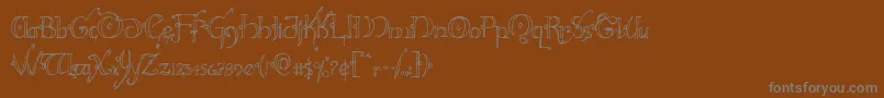 Hollyjinglecond-Schriftart – Graue Schriften auf braunem Hintergrund