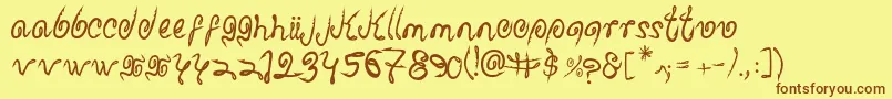 フォントSharkattack – 茶色の文字が黄色の背景にあります。