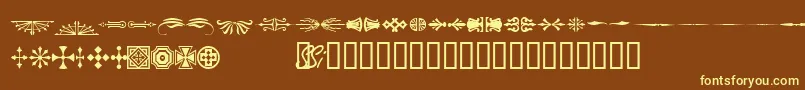 Woodcutornamentsonessk-fontti – keltaiset fontit ruskealla taustalla