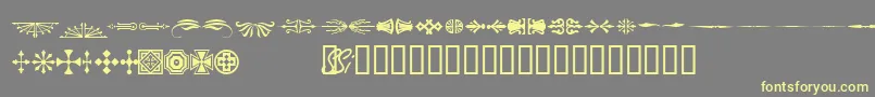 フォントWoodcutornamentsonessk – 黄色のフォント、灰色の背景
