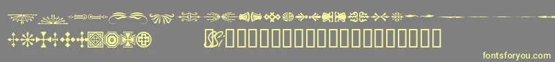 Woodcutornamentsonessk-fontti – keltaiset fontit harmaalla taustalla