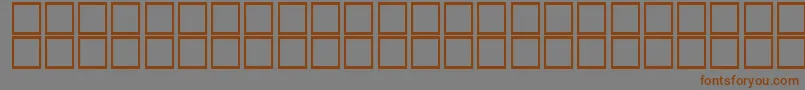 フォントKufiBoldItalic – 茶色の文字が灰色の背景にあります。