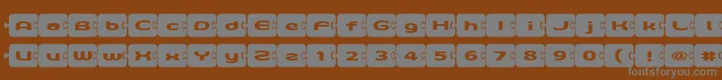 フォントD3Pazzlisma – 茶色の背景に灰色の文字