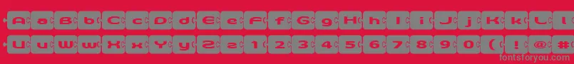 フォントD3Pazzlisma – 赤い背景に灰色の文字
