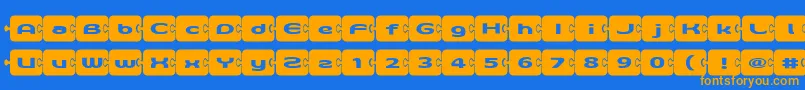 フォントD3Pazzlisma – オレンジ色の文字が青い背景にあります。