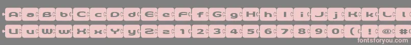 フォントD3Pazzlisma – 灰色の背景にピンクのフォント