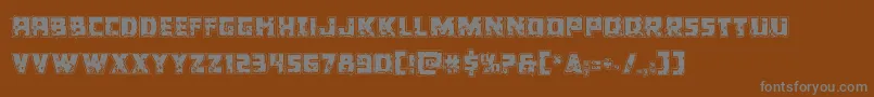 Colossusriddle-fontti – harmaat kirjasimet ruskealla taustalla