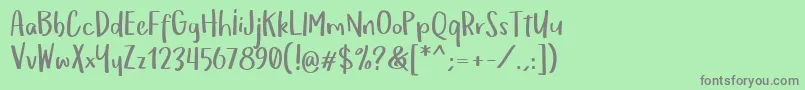 フォントOmTeloletOm – 緑の背景に灰色の文字