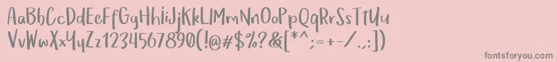 フォントOmTeloletOm – ピンクの背景に灰色の文字