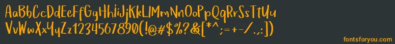 フォントOmTeloletOm – 黒い背景にオレンジの文字