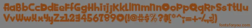 フォントKinkie – 茶色の文字が灰色の背景にあります。