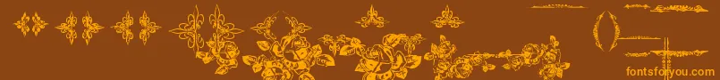 フォントEutemiaOrnaments – オレンジ色の文字が茶色の背景にあります。